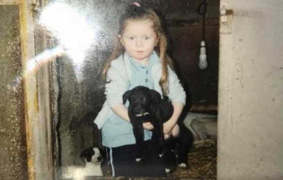 Debbie O'Rourke as a child with greyhound puppies