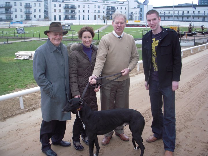 Michéal O' Muircheartaigh meeting his retirement gift in Shelbourne Park, Razldazl Rioga, trainer Dolores Ruth, Dick was chairman, Pauric Lodge of RTE Sport