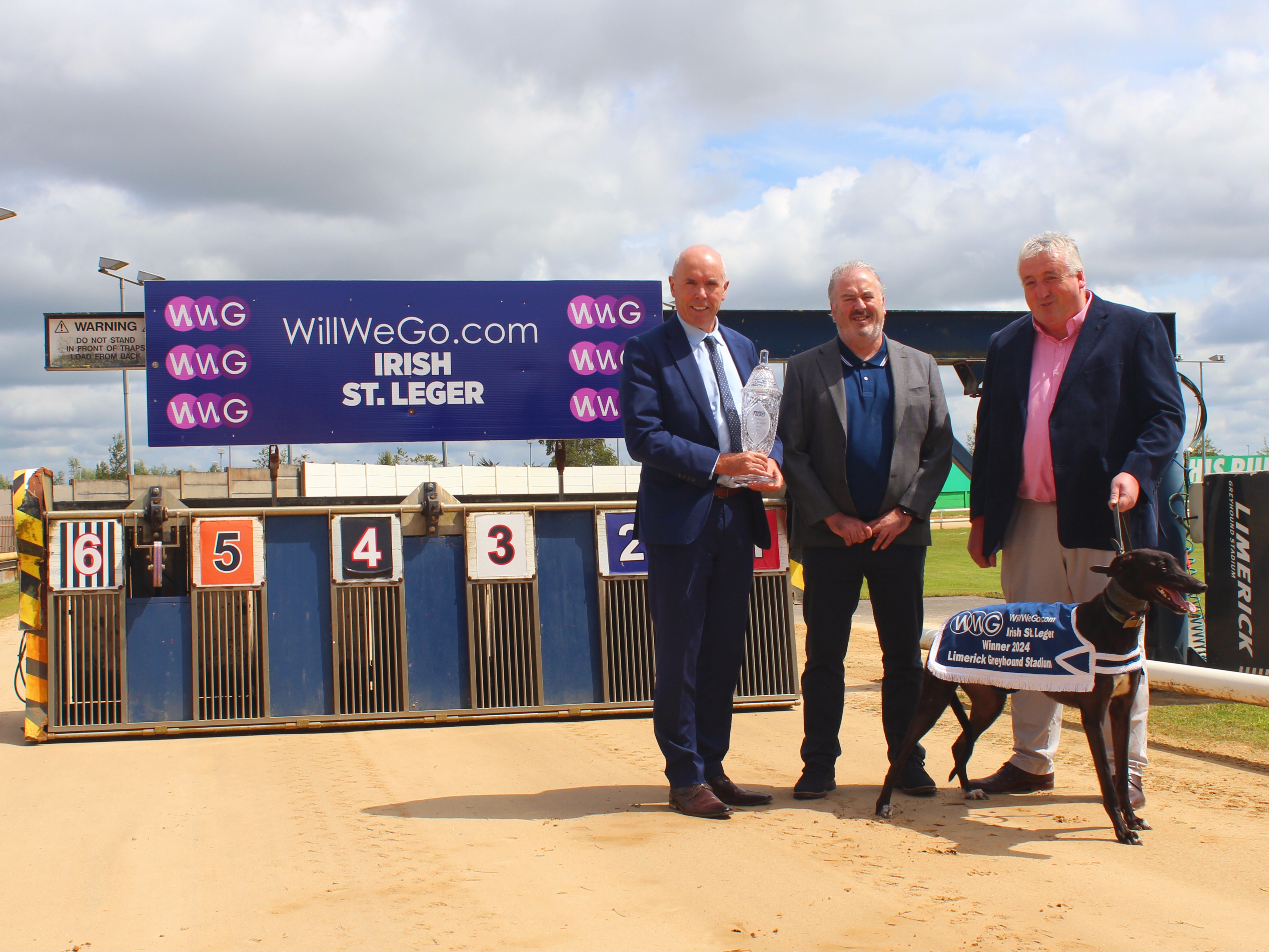 Tim Lucey CEO of GRI, holding the trophy for this year’s WillWeGo.com Irish St. Leger at Limerick Greyhound Stadium withRay Quinn, representing the sponsor, and Jody Thompson, Racing Manager, with Sombra the greyhound.
