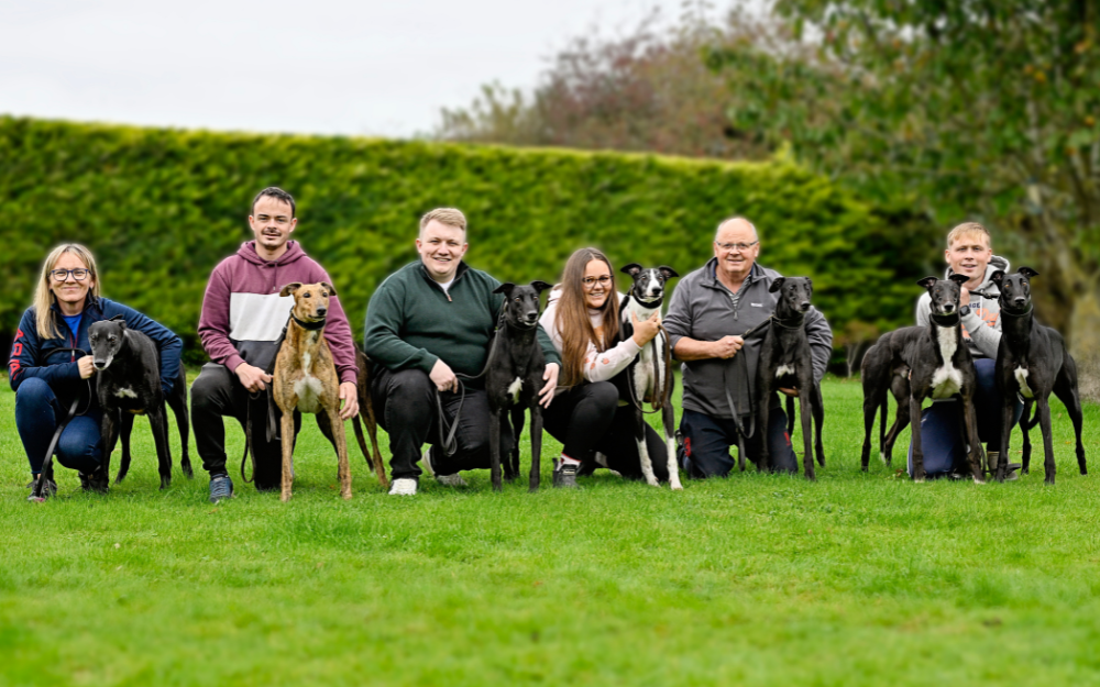 The Riverside Kennels team pictured with an incredible 7 Derby champions - 5 Irish Derby winners and 2 English Derby winners. Nicky Holland with 2016 Irish winner Rural Hawaii, Michael Fletcher with 2019 Irish Derby winner Lenson Bocko, Christopher Holland with 2020 Irish Derby winner Newinn Taylor, Rachel Holland with 2022 English Derby winner Romeo Magico, Graham Holland with 2023 English Derby winner Gaytime Nemo, and Timmy Holland with their two most recent winners 2024 Irish Derby champion Bockos Diamond and 2025 Irish Derby champion Cheap Sandwiches. Pic courtesy of Greyhound Racing Ireland Image shows 6 people holding 7 greyhounds in a green field area. The Riverside Kennels team pictured with an incredible 7 Derby champions - 5 Irish Derby winners and 2 English Derby winners. Nicky Holland with 2016 Irish winner Rural Hawaii, Michael Fletcher with 2019 Irish Derby winner Lenson Bocko, Christopher Holland with 2020 Irish Derby winner Newinn Taylor, Rachel Holland with 2022 English Derby winner Romeo Magico, Graham Holland with 2023 English Derby winner Gaytime Nemo, and Timmy Holland with their two most recent winners 2024 Irish Derby champion Bockos Diamond and 2025 Irish Derby champion Cheap Sandwiches. Pic courtesy of Greyhound Racing Ireland
